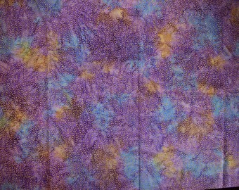 May include: Purple fabric with a white polka dot pattern and a tie-dye design in shades of blue, brown, and yellow.