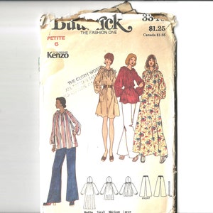 May include: A vintage sewing pattern for a hooded blouse and pants. The pattern is by Kenzo and is for a petite size 6. The pattern includes instructions for making the blouse and pants in different sizes, including petite, small, medium, and large.