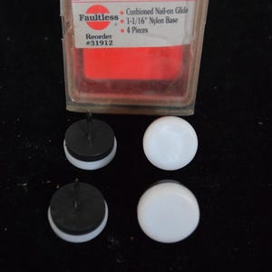 May include: A package of Faultless floor protection cushions. The package contains four pieces of cushioned nail-on glides with a 1-1/16" nylon base. The package has the text "Floor Protection" and "Faultless" printed on it.