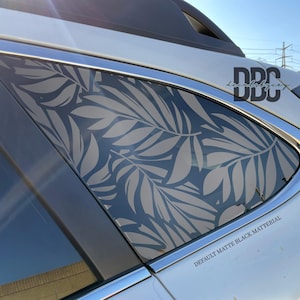 May include: A car window featuring a leaf design in light grey against a dark grey backdrop. The text "DEFAULT MATTE BLACK MATERIAL" is displayed at the bottom of the window.
