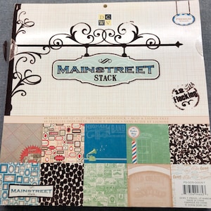 May include: A package of 48 sheets of 12x12 inch printed cardstock with a Mainstreet Stack theme. The cardstock is acid and lignin free. The package features a vintage-style sign with the text "Mainstreet Stack" and a design of a barber shop pole. The package also includes a sample of the cardstock with a variety of designs, including a vintage truck, a gramophone, and a barber shop sign. The cardstock is 12 with flocking.