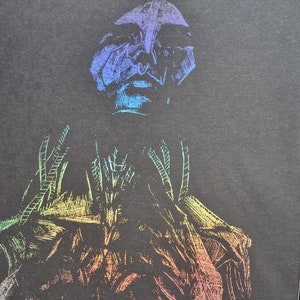 May include: A rainbow holographic drawing of a person with a detailed face and body. The drawing is on a black background.