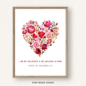 May include: A framed wall art print featuring a heart-shaped arrangement of watercolor flowers in shades of red, pink, and burgundy. Below the floral heart, the text reads: I AM MY BELOVED'S & MY BELOVED IS MINE, SONG OF SOLOMON 6:3.