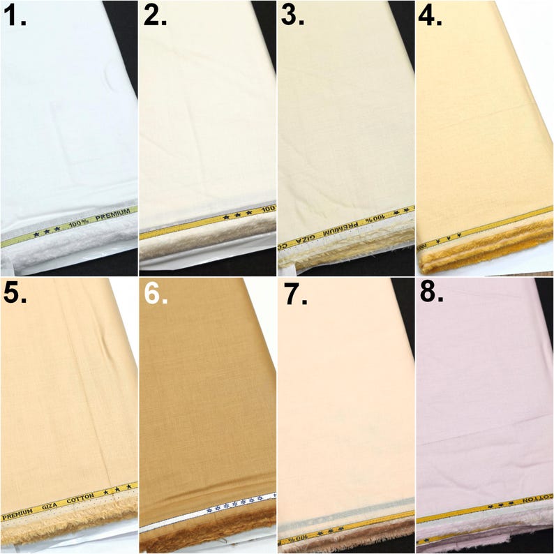 May include: A collection of eight folded fabric bolts in various shades including white, cream, beige, tan, and light pink. Each bolt features a decorative yellow and black trim along the bottom edge with the text 100% PREMIUM GIZA COTTON.