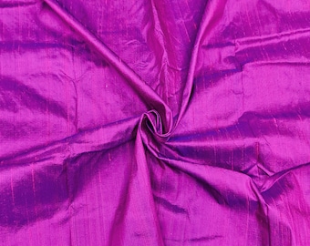 May include: A close-up of a vibrant purple fabric with a subtle sheen. The fabric is folded and draped, showcasing its texture and drape.