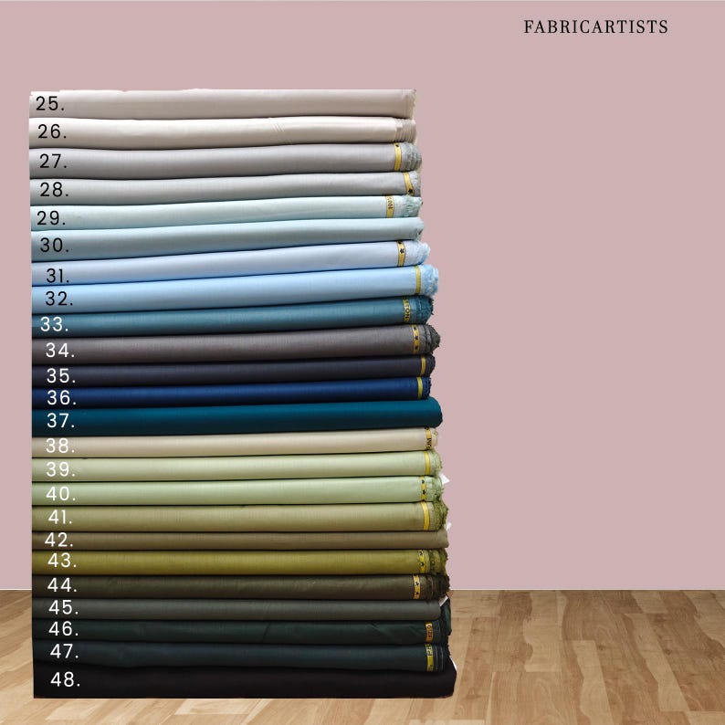 May include: A vertical stack of folded fabric bolts labeled with numbers 25 through 48, displaying a gradient of colors ranging from light gray and blue to various shades of green, olive, brown, and dark charcoal, with the text FABRICARTISTS.
