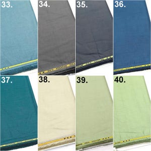 May include: A collection of eight fabric swatches labeled 33 through 40, featuring various solid colors including light blue, gray, dark gray, navy, teal, cream, light green, and lime green, each with a yellow selvage edge marked 100% PREMIUM GIZA COTTON.