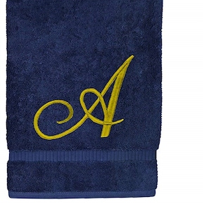 May include: A dark blue hand towel with a gold embroidered letter A.