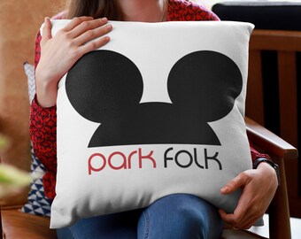 May include: White throw pillow with a black silhouette of Mickey Mouse ears and the text "park folk" in red.