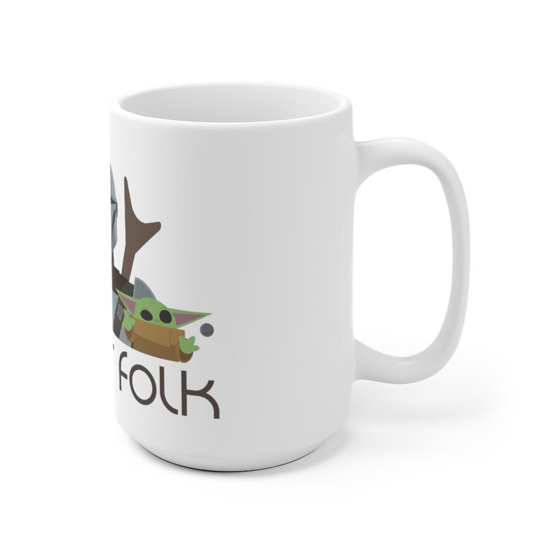 May include: White ceramic mug featuring a graphic of a Mandalorian and a Baby Yoda character. The text "Folk" is printed below the characters.