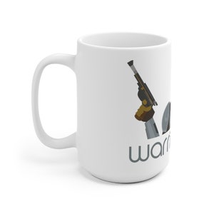 May include: White ceramic mug featuring a black and grey illustration of a hand holding a blaster and the word "warriors" in grey text.