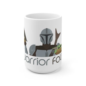May include: White ceramic mug featuring a graphic of a Mandalorian character, a Grogu character, and the text "Warrior Found" in grey.