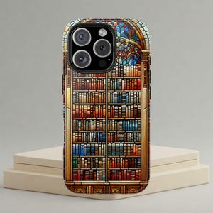 May include: A phone case with a stained glass design of a bookshelf filled with books. The case has a black border and a camera cutout.