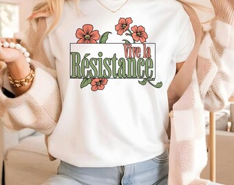 May include: White t-shirt with a green box and the text "Vive la Resistance" in white. The box is surrounded by pink flowers.