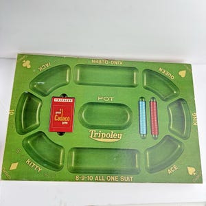 May include: A green Tripoley game board featuring recessed sections for cards and chips. The board includes text labels for Jack, Queen, King, Ace, Kitty, and Pot, along with the text 8-9-10 ALL ONE SUIT and a red Cadaco game card insert.