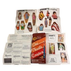 May include: A collection of vintage knitting supplies, including pattern booklets and a box of "One Needle Looper" needles. The booklets feature illustrations of knitted garments and instructions. The box is red and orange with the text "One Needle Looper".