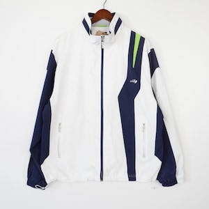 May include: White windbreaker jacket with blue and green color block design. The jacket has a zipper closure and two zippered pockets.