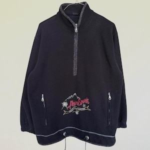 May include: Black fleece pullover with a half-zip closure and two zippered pockets. The front features an embroidered design with the words "Alpine Sports" in red and gold, along with a mountain graphic. The hemline has a drawstring.