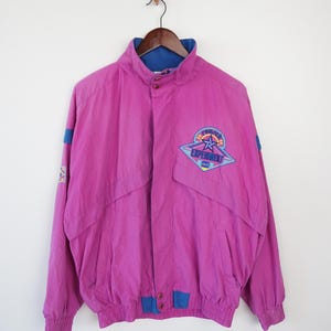 May include: A pink vintage jacket with a blue lining and a colorful "Florida Experiment" logo on the front.