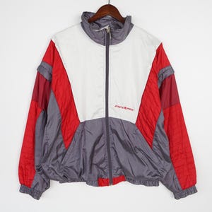 May include: A vintage gray, red, and white windbreaker jacket with a zipper closure and the text "Athletic Express" on the front.