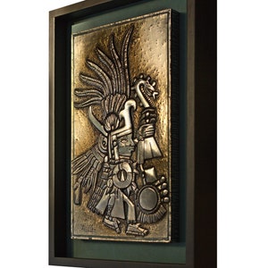 Huitzilopóchtli. Left-handed hummingbird. Embossed in aluminum. Metal embossing. Aztec art. Wall decorations. Aztec culture. Prehispanic Mexico