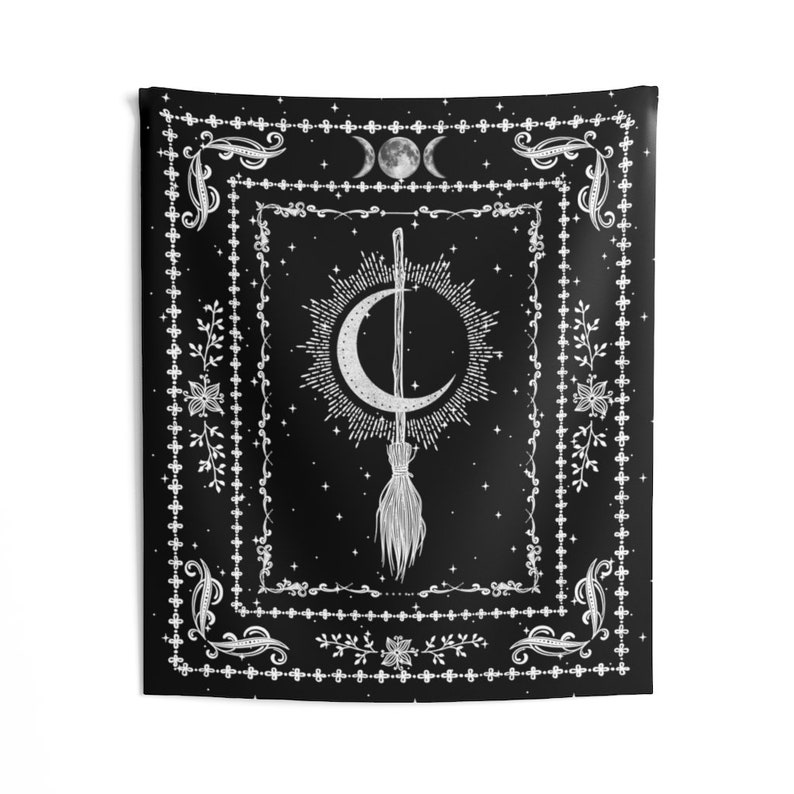 May include: Black and white tapestry with a crescent moon and a broom in the center. The design is surrounded by a decorative border with floral motifs and stars.
