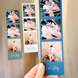 May include: Photo booth style magnets with three images each, featuring a couple in various poses. The magnets are blue and white, with the words "Love Story" in cursive. The images show the couple hugging and sitting on a bicycle.