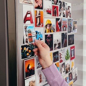 Hands holding a beautifully printed custom photo magnet, emphasizing the magnet's thickness and quality finish