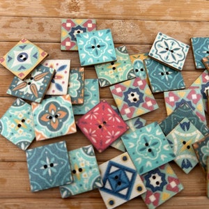 May include: Assortment of colorful square wooden buttons with intricate tile-like patterns. The buttons feature a variety of colors, including blue, green, red, yellow, and white.