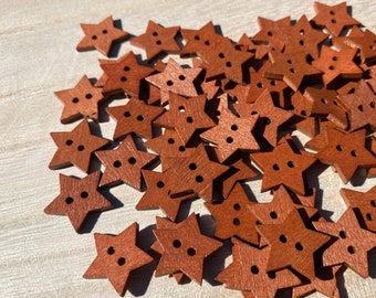 May include: A pile of brown wooden star-shaped buttons. The buttons have two holes each.