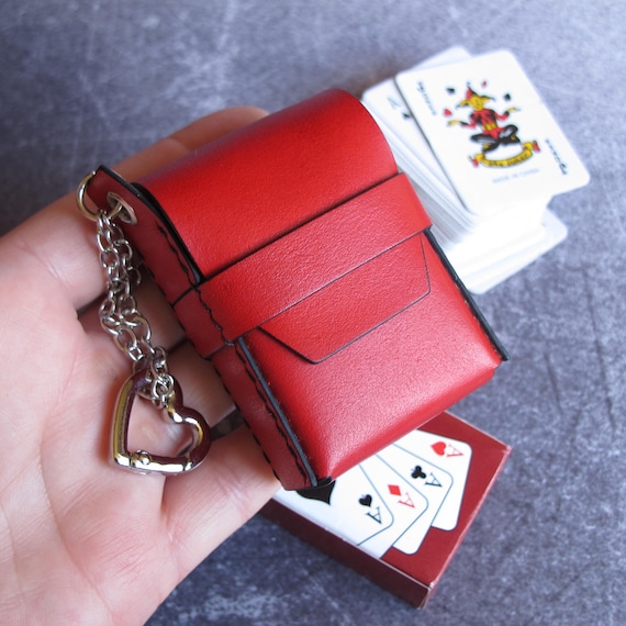 Hand-stitched red leather case sized perfectly for a mini playing card deck — a tiny luxury accessory that card game lovers or magicians will actually use.