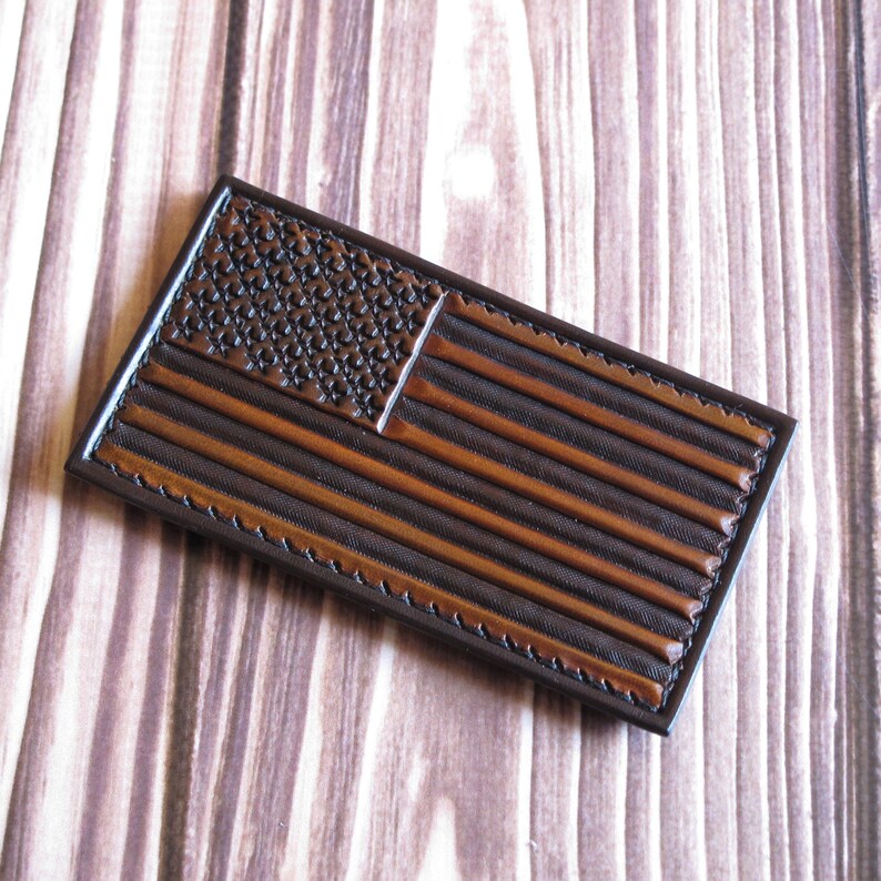 Tan American flag patch is made of vegetable tanned leather. Volumetric hand embossing. Careful hand painting.
The Leather patch is attached with velcro and is ready to ship.