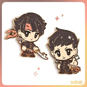 May include: Two enamel pins featuring anime-style characters in black uniforms with gold accents. One pin has a red headband and a sword, the other has a thumbs-up gesture. The pins have a gold border and are set against a soft pink background.