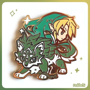 May include: A gold-colored enamel pin featuring a green wolf and a blonde-haired character with a green hat. The wolf has white accents and a chain around its front legs. The pin has a shiny finish and is set against a white background.