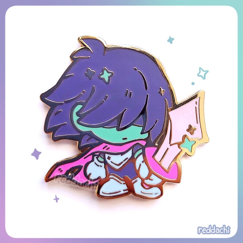 May include: A gold-colored enamel pin featuring a cartoon character with purple hair, a green face, and a pink scarf. The character is wearing armor and holding a pink and gold object. The pin has a gold border and is set against a white background.