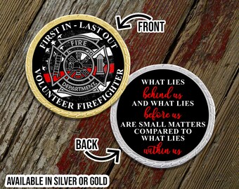 May include: A gold and silver challenge coin with a firefighter theme. The front features a firefighter helmet, ladder, and the words "First In - Last Out Volunteer Firefighter". The back features the quote "What lies behind us and what lies before us are small matters compared to what lies within us".
