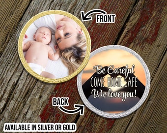 May include: Gold and silver round coin with a photo of a mother and baby on the front and a sunset with the text "Be Careful COME HOME SAFE We love you!" on the back.