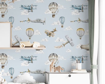Wallpaper with vintage plane in blue sky and clouds for boys room