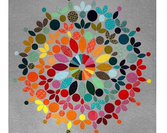 May include: A colorful modern mandala quilt with a gray background. The quilt is made up of various shapes and sizes of fabric in shades of red, orange, yellow, green, blue, purple, and pink. The quilt is titled "Modern Mandala Quilt" and is by Carolyn Murfitt.