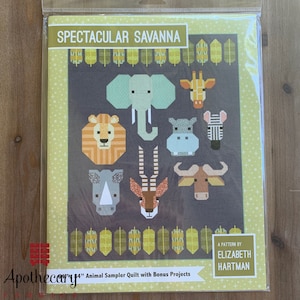 May include: A pattern for a quilt featuring a variety of animals from the savanna, including a lion, elephant, giraffe, zebra, rhino, hippopotamus, and antelope. The pattern is titled "Spectacular Savanna" and is by Elizabeth Hartman.