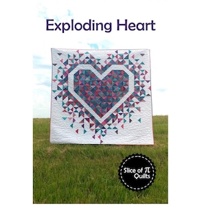 May include: A quilt featuring a large pink and blue heart design. The heart is surrounded by smaller triangles in various shades of blue, pink, and white. The quilt is titled "Exploding Heart" and is made by "Slice of Pi Quilts".