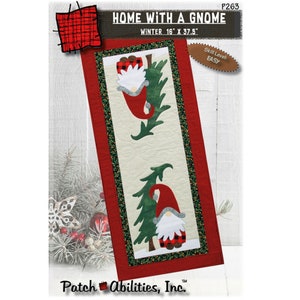 May include: A quilting pattern for a table runner featuring a gnome with a red hat and a plaid shirt, standing next to a green Christmas tree. The pattern is titled "Home with a Gnome" and is 16 inches by 37.5 inches. The skill level is listed as easy.