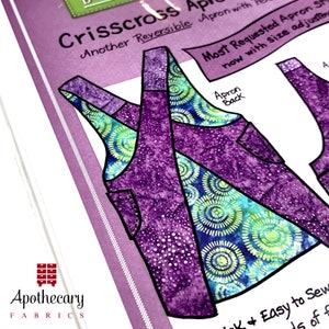 May include: A sewing pattern for a reversible crisscross apron with a purple and green floral print. The pattern includes instructions for adjusting the size. The text "Apron Back" is written on the pattern.