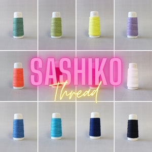 May include: Ten spools of Sashiko thread in various colors, including green, yellow, orange, white, blue, turquoise, and black. The spools are labeled "Sashiko Thread".