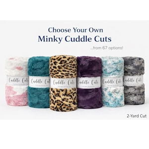 May include: A selection of Minky Cuddle Cuts fabric rolls in various colors and patterns, including leopard print, teal, and purple. Each roll is labeled with "Cuddle Cuts" and is a 2-yard cut.