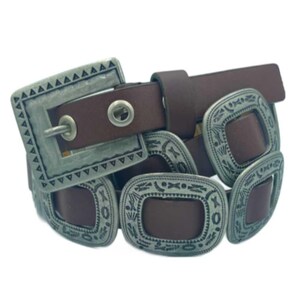 May include: A brown leather belt with multiple silver-toned buckles featuring intricate designs. The buckles are rectangular with rounded corners and have a distressed finish.