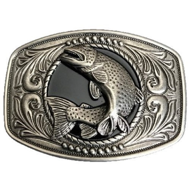 May include: Silver-toned belt buckle with an ornate design featuring a jumping fish. The fish is in the center of the buckle and is surrounded by a decorative border.