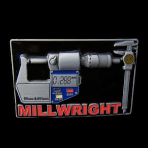 Op de afbeelding: Een zilveren metalen pin met een zwarte achtergrond. De pin heeft een zilveren schuifmaat met een blauw digitaal display dat "0,288 mm" aangeeft. De tekst "MILLWRIGHT" staat in rode letters onder de schuifmaat.