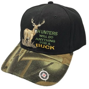 May include: Black baseball cap with a camouflage brim. The front of the cap features an embroidered image of a deer and the text "Hunters will do anything for a buck".
