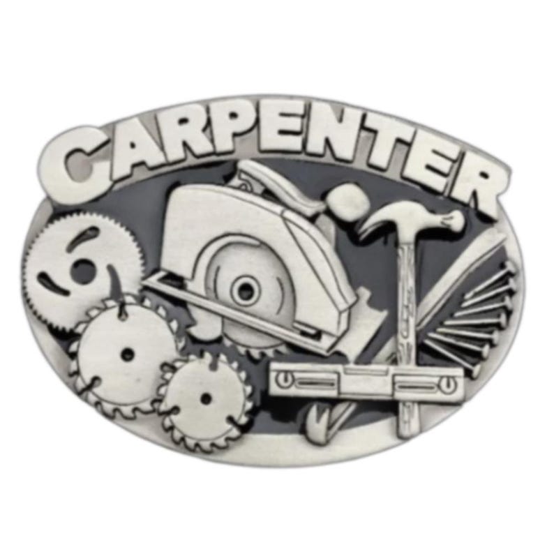 May include: Oval-shaped silver-tone belt buckle with the word "CARPENTER" in raised letters. The buckle features a circular saw, hammer, nails, and other carpentry tools. The background is black.